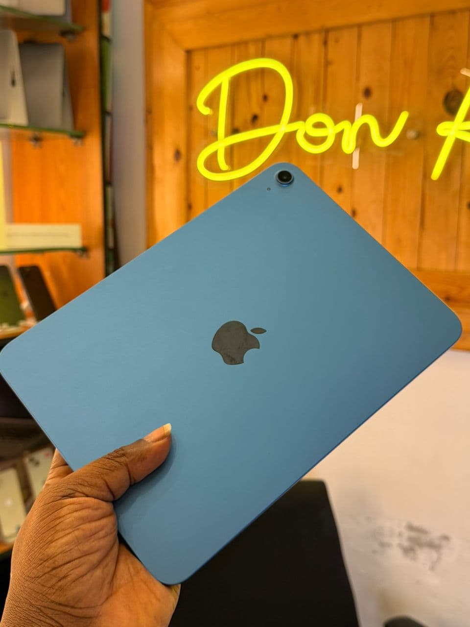 iPad Air in sky blue held in store
